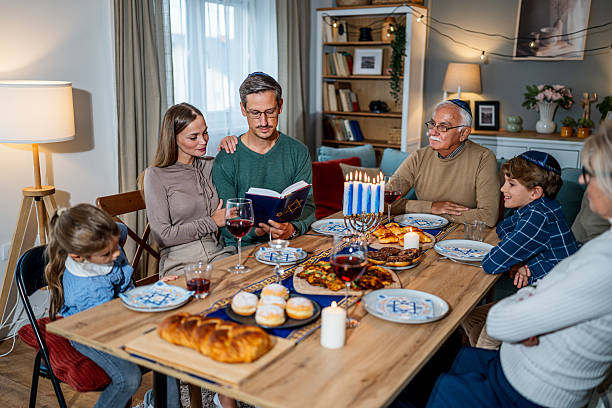 istock Extended family celebrating Hanukkah with traditional dinner 2235195235
