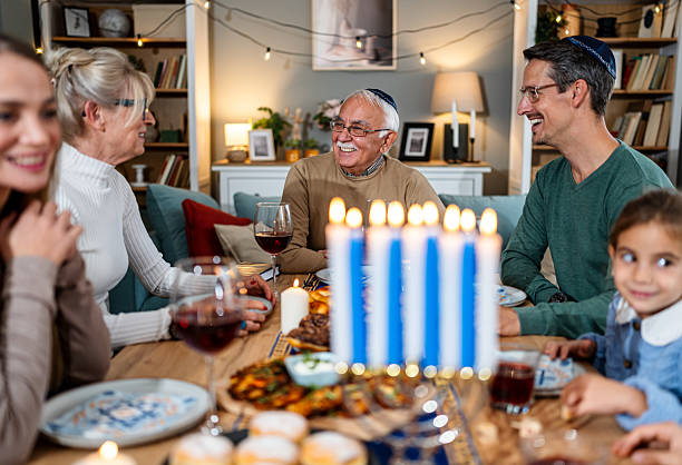 istock Extended family celebrating Hanukkah with festive dinner 2235196888