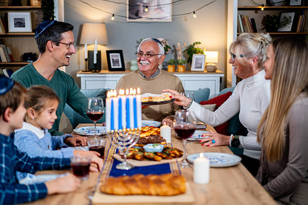 istock Extended family celebrating Hanukkah with festive dinner 2235197079