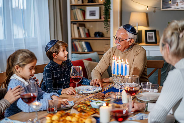 istock Extended family celebrating Hanukkah with festive dinner 2235197122
