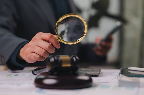 istock Examining Legal Document Magnifying Glass, Right-hand Holding, Desk Gavel, Mobile, Chart, Due Diligence, Compliance, Right Justice, Business Law, Courtroom 2235197263