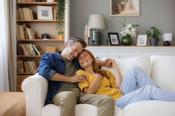 istock Couple relaxing on sofa, enjoying time together at home 2235198202