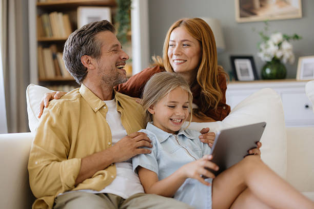 istock Happy Family Relaxing Together on Couch 2235198805
