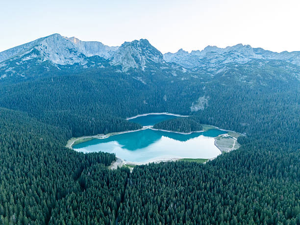 istock Aerial View of Mountain Lake Surrounded by Forest 2235200110