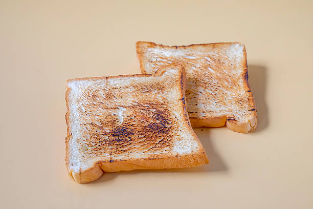 istock Slices of freshly toasted bread on color background. 2235208285
