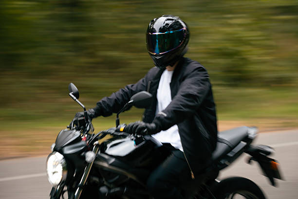 istock Man on a motorcycle in the forest. 2235208764