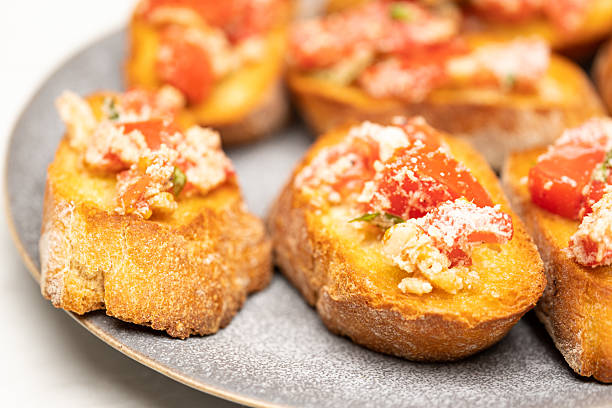 istock Delicious Baguette Appetizer with Cheese, Tomato and Spices on Plate 2235210164