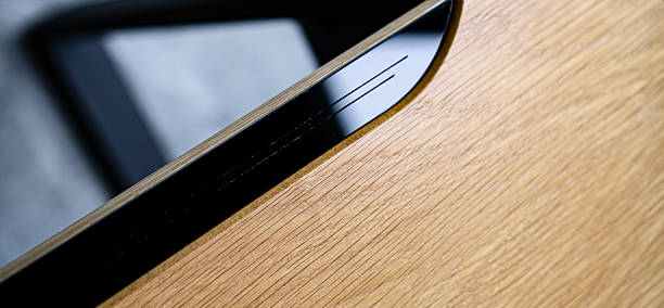 istock Empty rough wooden table top in the dark room 2235210251