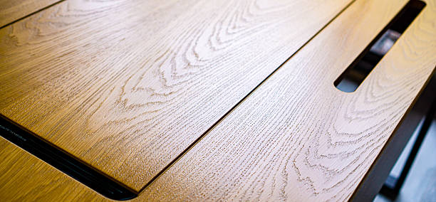 istock Empty rough wooden table top in the dark room 2235210291