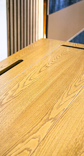 istock Empty rough wooden table top in the dark room 2235210582