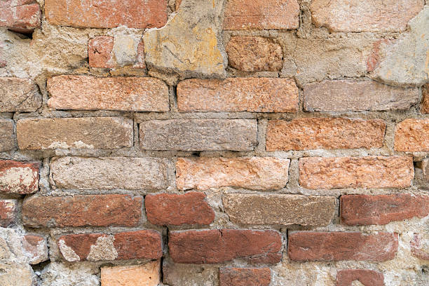 istock Detailed close-up of a weathered brick wall surface 2235213381
