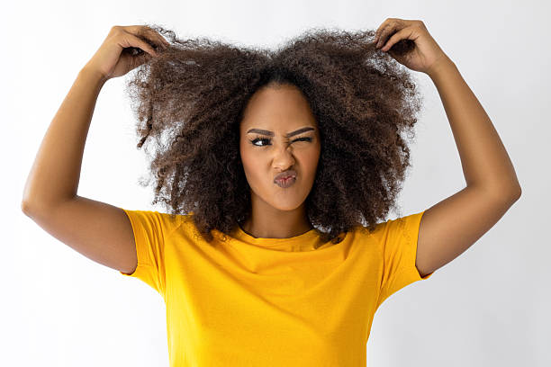 istock Female with afro hair pulling her hair 2235214101