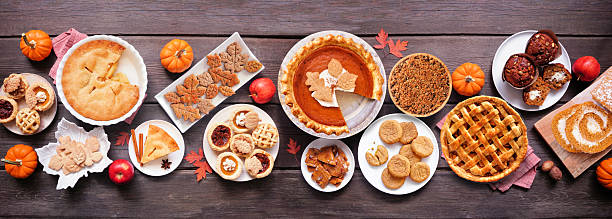 istock Autumn desserts table scene. Overhead view on a dark wood banner background. 2235221810