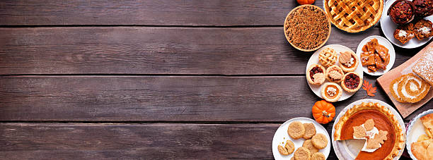 istock Autumn desserts side border. Top down view over a dark wood banner background. 2235221811