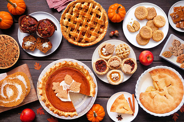 istock Autumn desserts table scene. Overhead view on a dark wood background. 2235221843