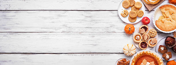 istock Autumn desserts side border. Top down view over a white wood banner background. 2235222069