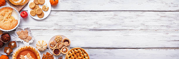 istock Autumn desserts corner border. Overhead view on a white wood banner background. 2235222151