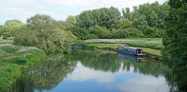 istock The river Nene at Stanwick Nothamptonshire with narrow boat and trees 2235223430