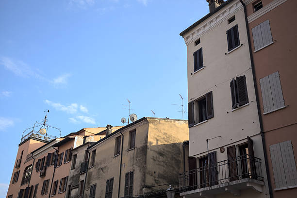 Facades with balconies of buildings in an italian town at sunset