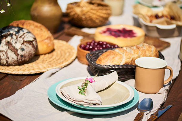 istock Outdoor Table Setting Featuring Fresh Bread and Pastries during Gathering 2235225490