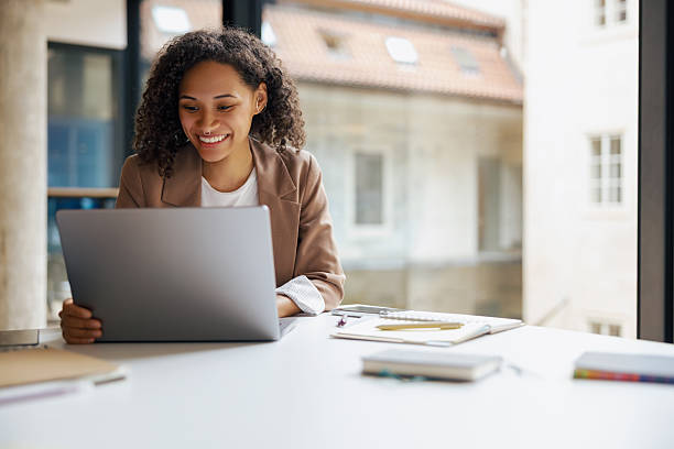 istock A young professional diligently working on a laptop within a modern and stylish office space 2235229043