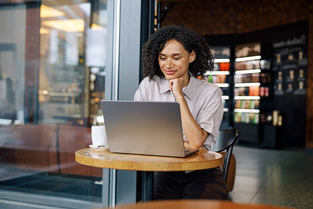 istock Concentrated Woman Diligently Working on Her Laptop While Enjoying a Cafe Atmosphere 2235230505