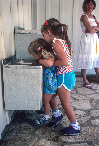 istock Texas - Girl Helps Sister Get a Drink - 1984 2235231993
