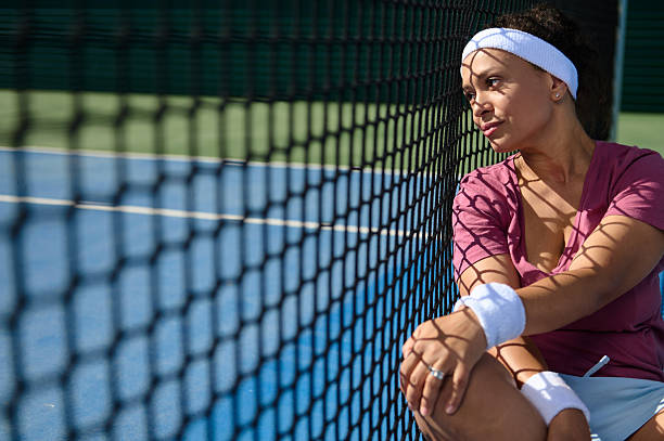istock Tennis Player Relaxing Beside Court with Focus on Net Patterns 2235233291