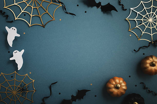 istock Halloween party frame from pumpkins, bats, spider web, ghosts on blue background top view. 2235233934