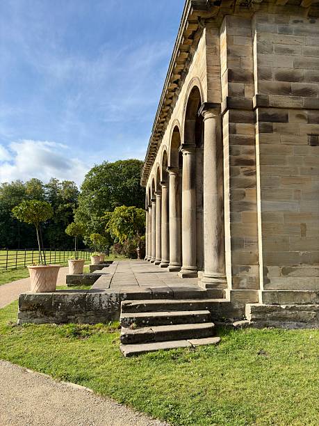 istock Stone columns form a classical colonnade in an outdoor setting, bathed in warm sunlight. A timeless architectural scene ideal for themes of history, heritage, symmetry, and grand design. 2235235807