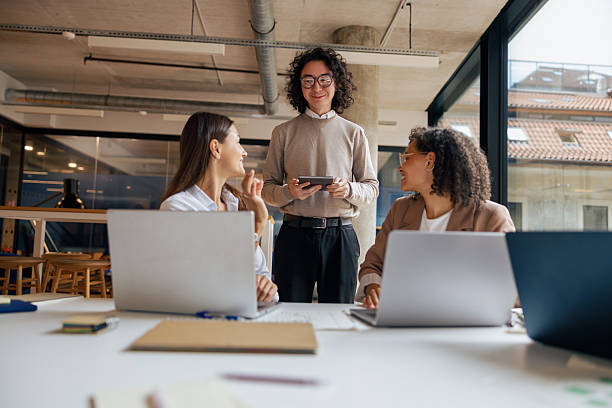 istock A Collaborative Meeting Takes Place in a Modern Workspace Filled with Laptops and Technology 2235235912