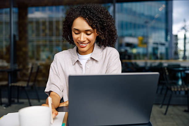 istock Focused Woman Working at Laptop in Modern Caf Environment 2235238287
