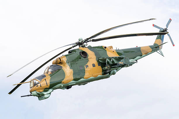 istock Camouflaged Soviet Mi-24 military attack helicopter in low flight 2235242355