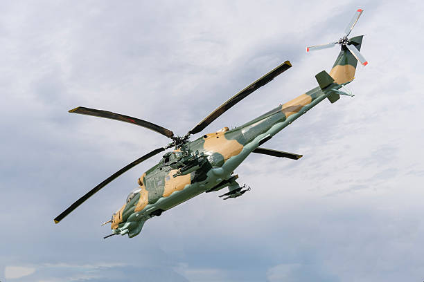 istock Camouflaged Soviet Mi-24 military attack helicopter in low flight 2235242358