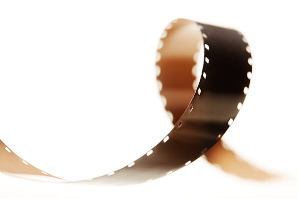 Strip of 35mm cinema film twisting and curling into a fluid, dynamic form