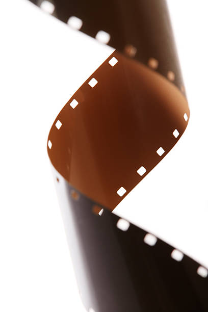 Strip of 35mm cinema film twisting and curling into a fluid, dynamic form