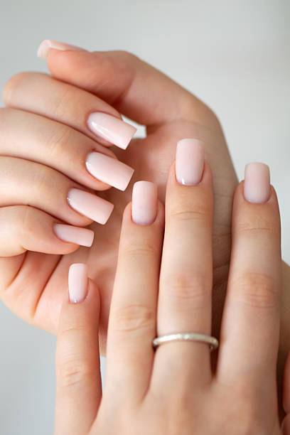 istock Elegant female hands with nude manicure and silver ring 2235246531