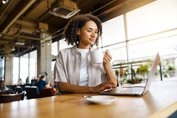 istock A Focused Woman Deeply Engaged in Her Work on a Laptop While Enjoying Coffee in a Modern Cafe 2235248320