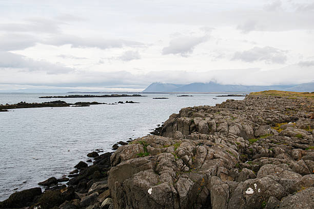 istock Rocky coastline with distant mountains in Iceland under cloudy skies 2235250406
