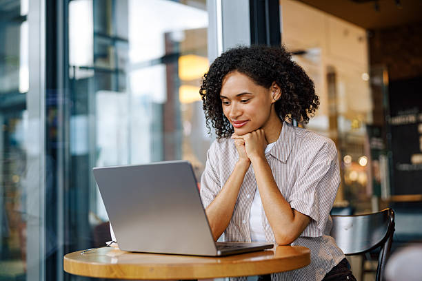 istock A Focused Professional Woman Working Diligently on Her Laptop in a Modern Cafe Setting 2235252546