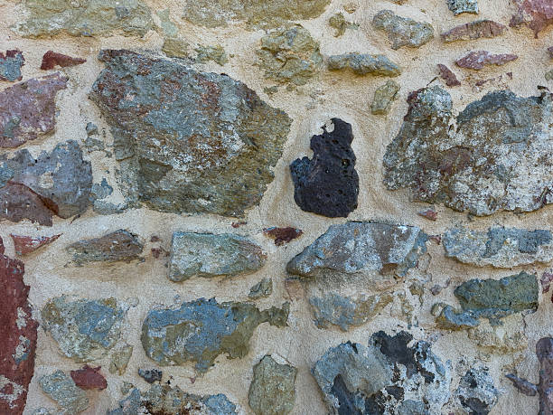 istock Close-up of rustic stone wall with irregular granite rocks 2235253047