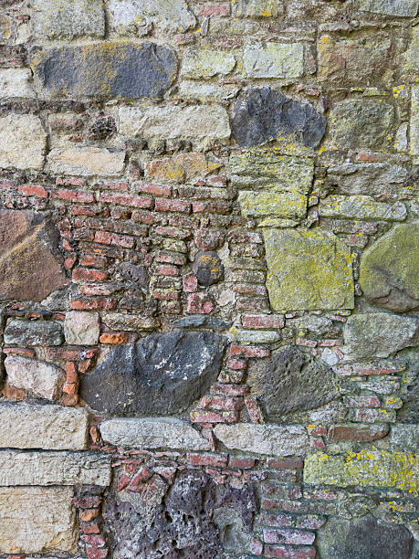 istock Close-up of rustic stone wall with irregular granite rocks 2235253517