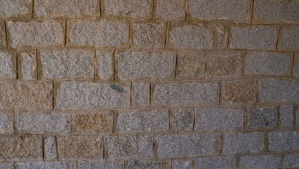 istock Close-up of rustic stone wall with irregular granite rocks 2235253885