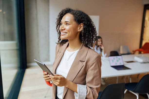 istock A Confident and Ambitious Businesswoman in a Modern Workspace Utilizing a Tablet 2235255184