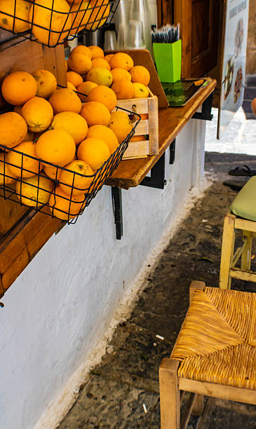 istock Oranges hanging on a wooden window shutter and chairs, ready for making orange juice. Rhodes island, Greece 2235256948