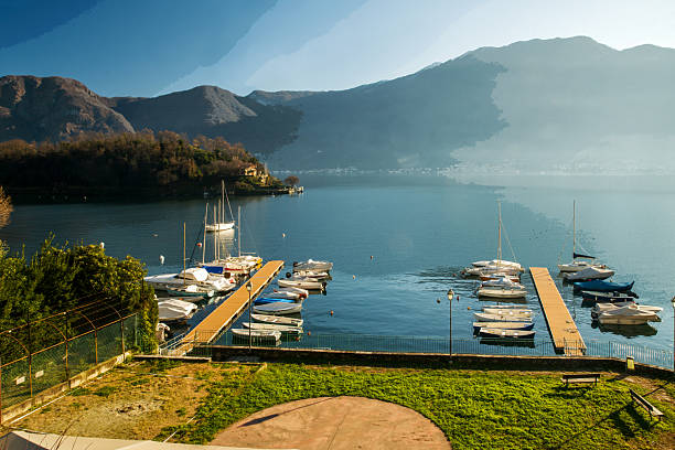 Helicopter pad on the Swiss lake  - possibly Kabaeva  Putin's mistress lands here , Sunny da - snowcapped mountains of Swiss Alps.