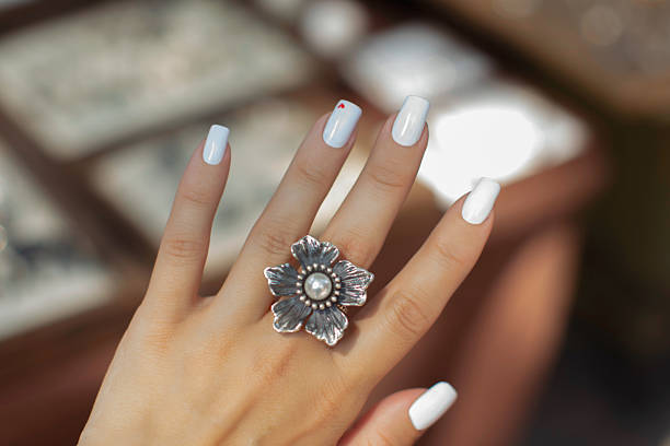 istock Female hand with ring in shape of flower 2235268008