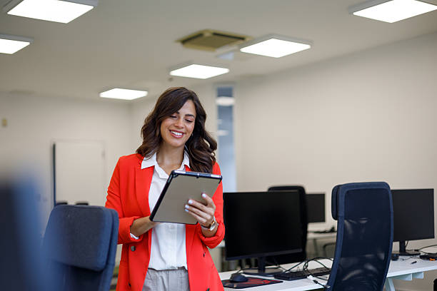 istock Professional woman working on digital tablet, displaying confidence in contemporary workplace with bright, focused expression 2235270390