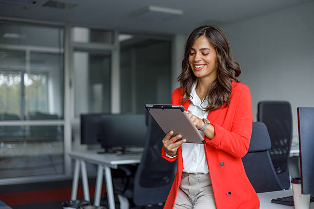 istock Professional businesswoman smiling while working on digital tablet, representing modern workplace productivity and technology 2235270651