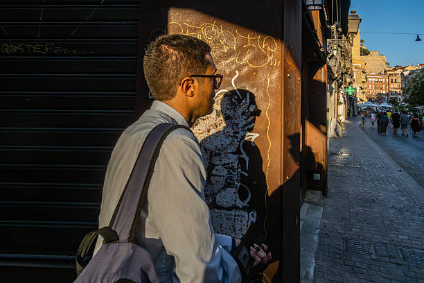 Cagliari, Sardinia, Italy Aug 5, 2025 A man walks in the setting sun in the Old City